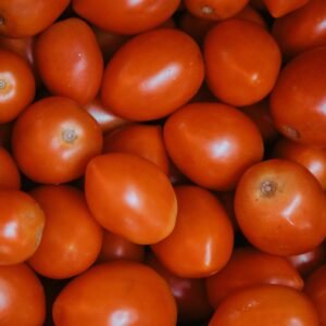 Close-up of vibrant red Roma tomatoes, perfect for culinary uses and food decoration.